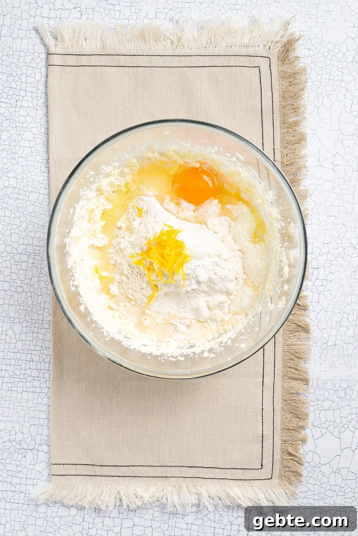 An image of adding an egg to the bowl.