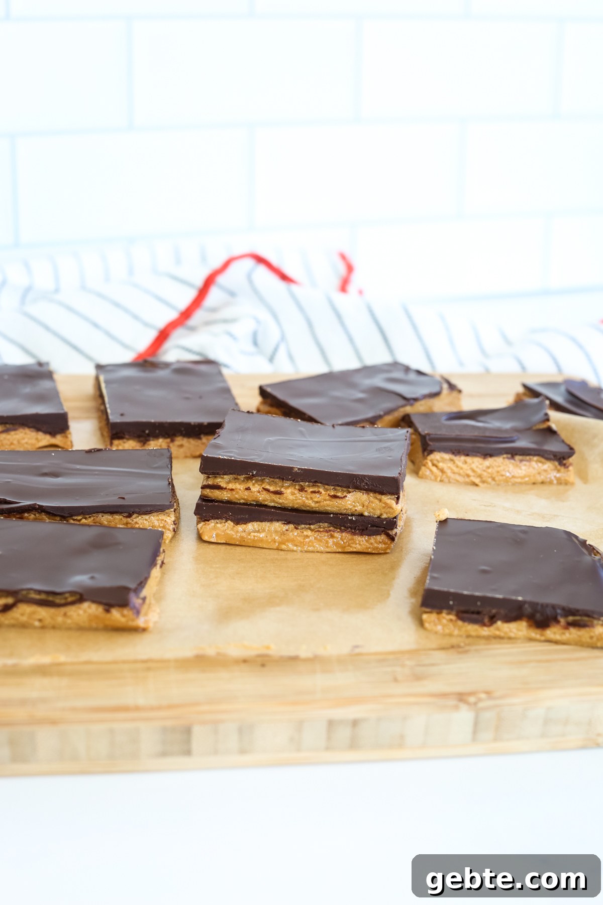 a number of chocolate peanut butter protein bars on a cutting board