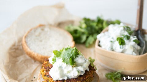 red lentil veggie burgers with mint raita on a plate