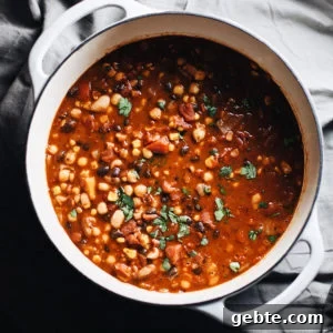 A white dutch oven with vegetarian bean chili.