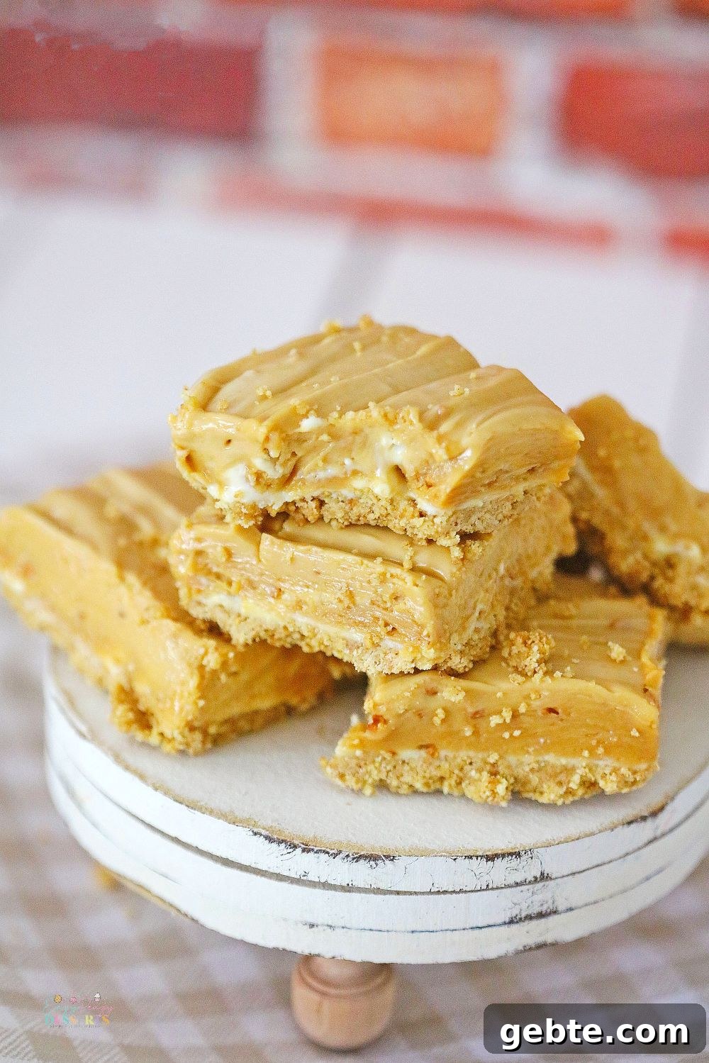 A few peanut butter cheesecake bars on a dessert serving plate