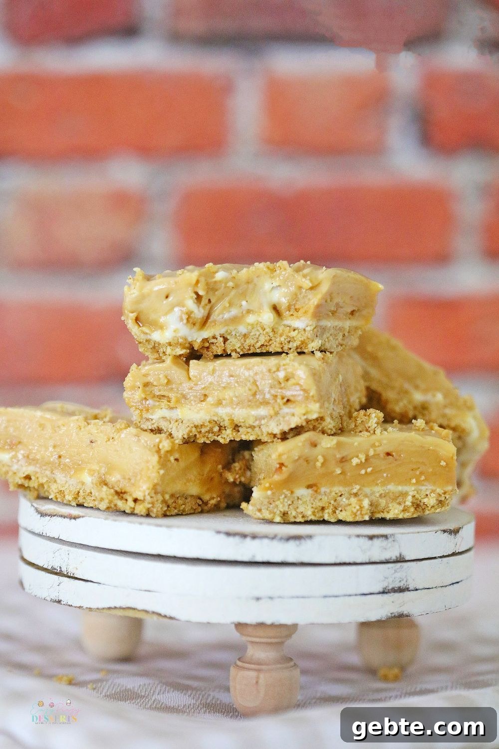 Close up image of a few squares of peanut butter chocolate fudge on a dessert plate