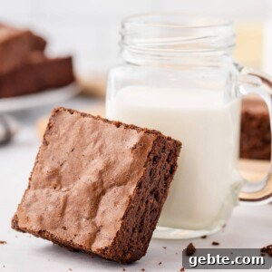Sea Salt Fudge Brownies Recipe with Gooey Chocolate Center 2 Brown Butter Brownie resting against a mason jar of milk