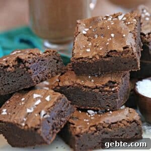 Sea Salt Fudge Brownies Recipe with Gooey Chocolate Center 4 A stack of Salted Fudge Brownie squares.