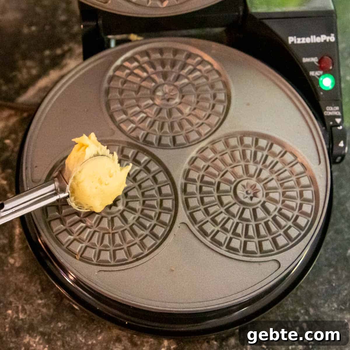Crisp Gluten-Free Pizzelle Recipe: Authentic Italian Cookies 4 batter going on a pizzelle iron.