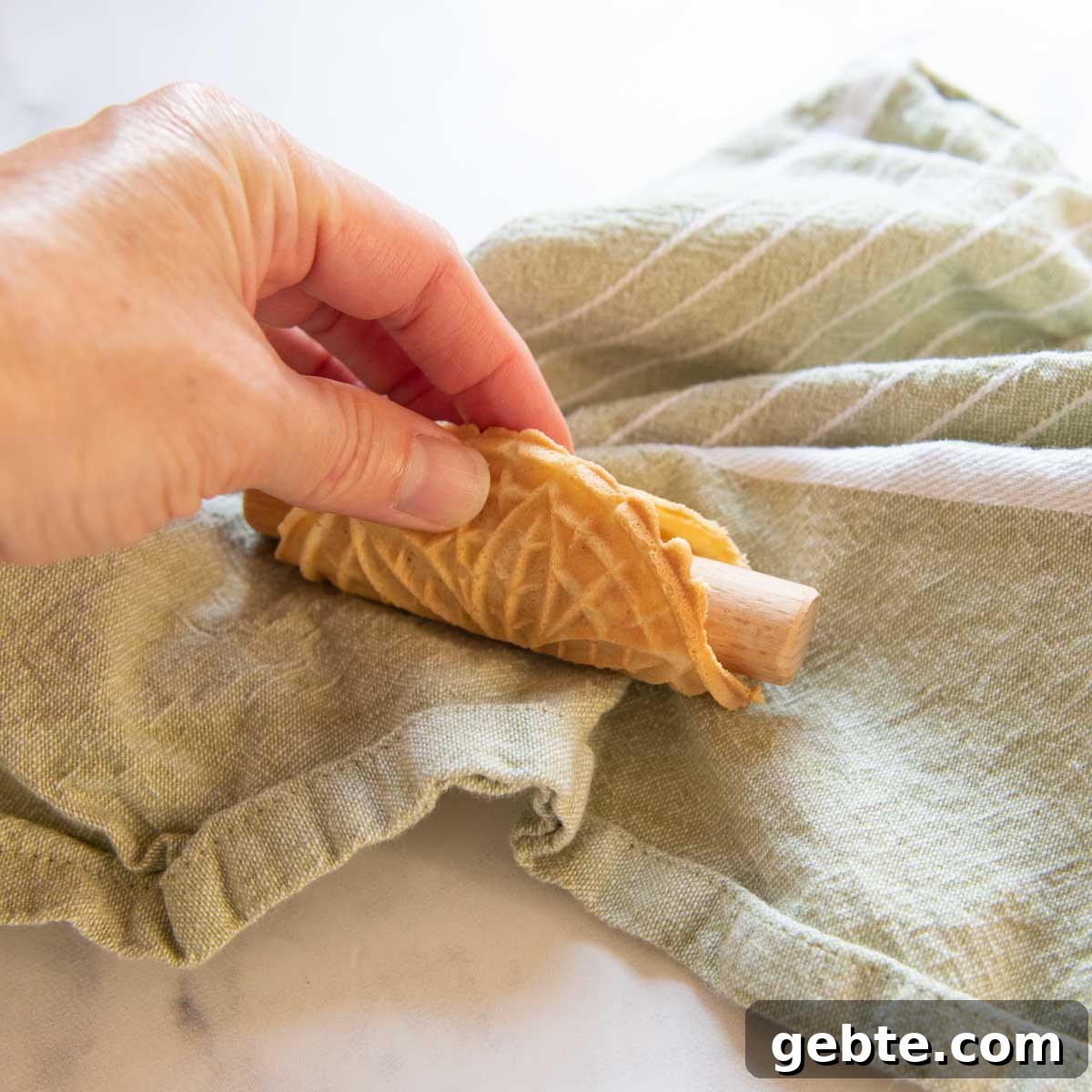 Crisp Gluten-Free Pizzelle Recipe: Authentic Italian Cookies 5 a small pizzelle wrapped around a rod.
