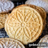 Crisp Gluten-Free Pizzelle Recipe: Authentic Italian Cookies 8 a gluten-free pizzelle leaning up against a stack with others around it.