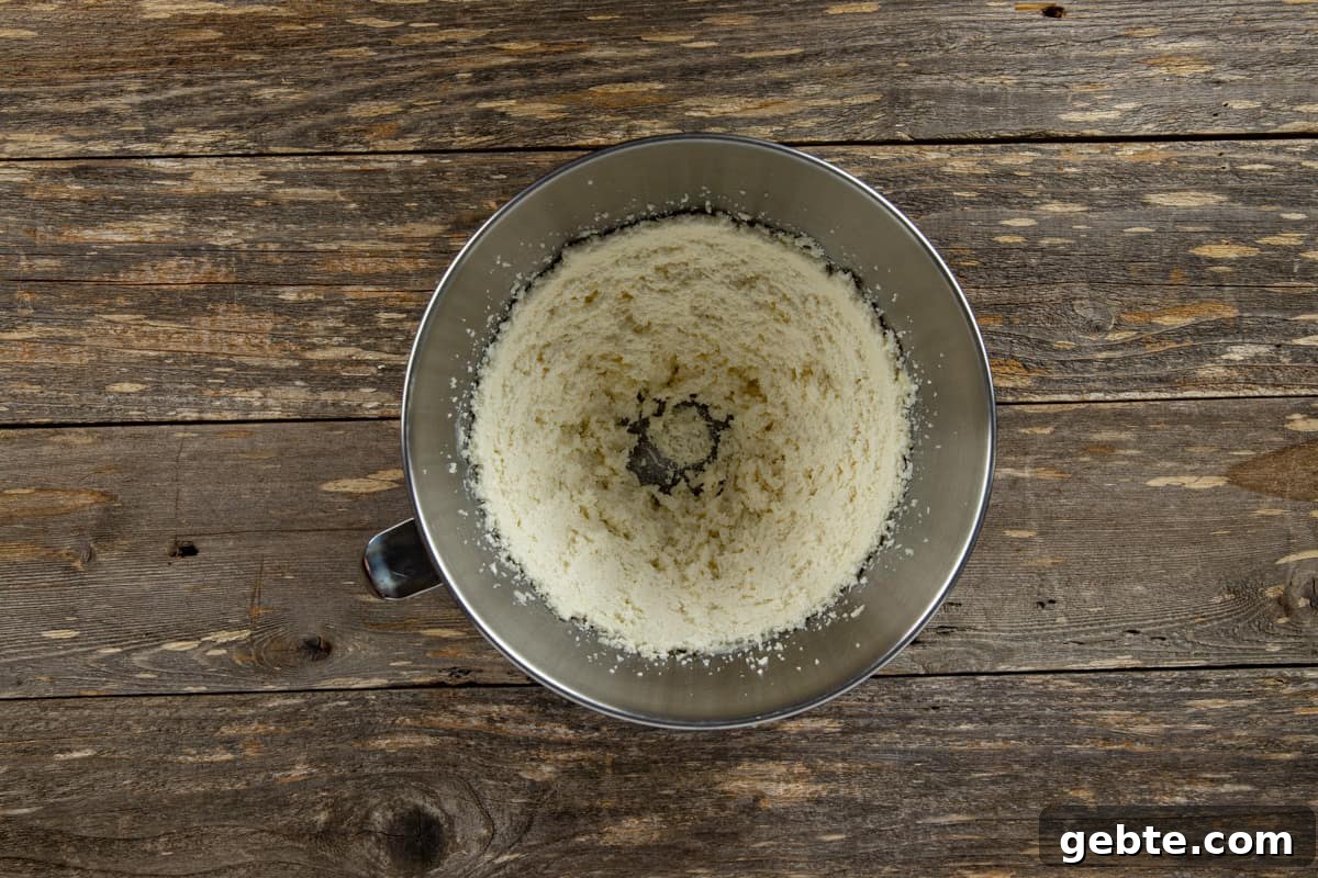 Creamed butter and sugar in stainless steel mixing bowl.