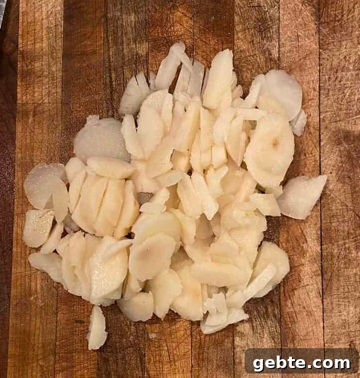 Diced water chestnuts on a cutting board.