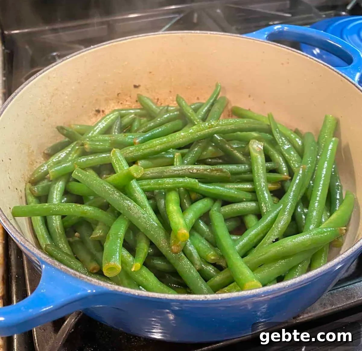 Green beans sautéing on the stove.
