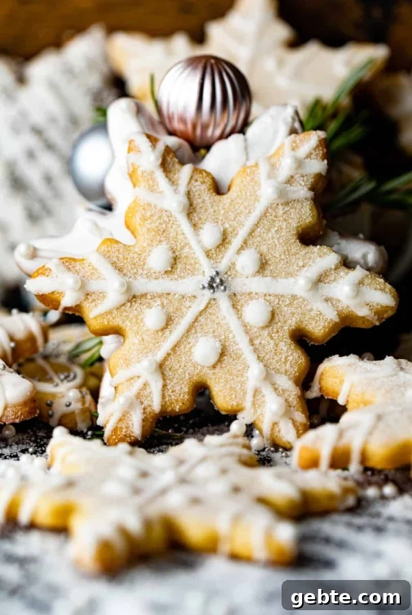 Crunchy Peppermint Chocolate Chip Cookies Recipe 17 snowflake cookies scattered around on a table.