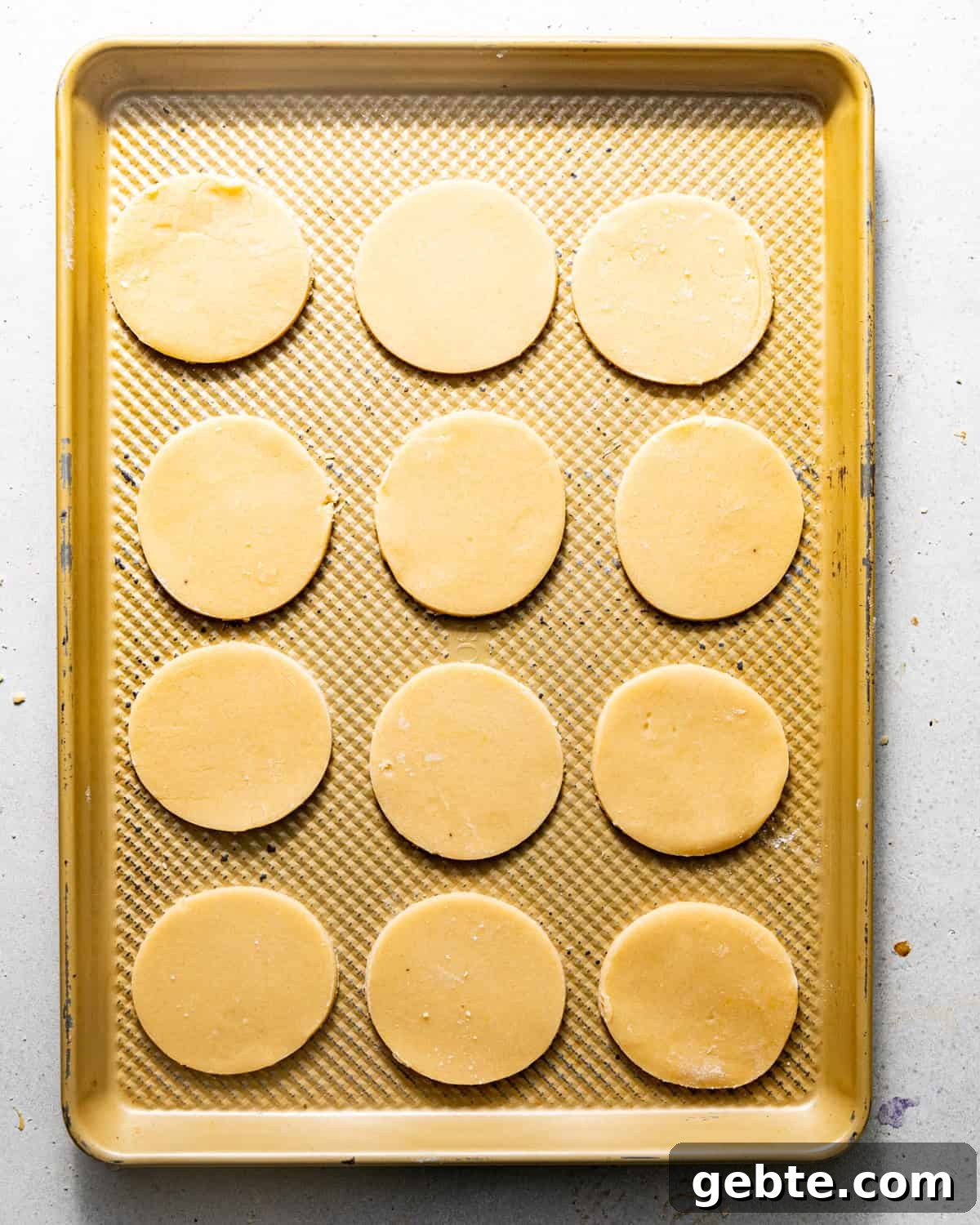 Crunchy Peppermint Chocolate Chip Cookies Recipe 7 peppermint cookie dough cutout on a baking sheet.