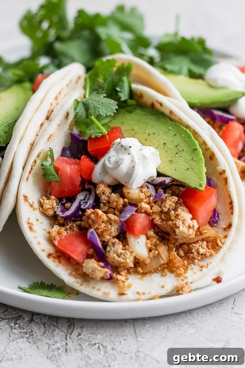 Quinoa and Tofu Taco Filling Recipe for Meatless Tacos 2 tortilla filled with vegan taco meat and fresh veggies