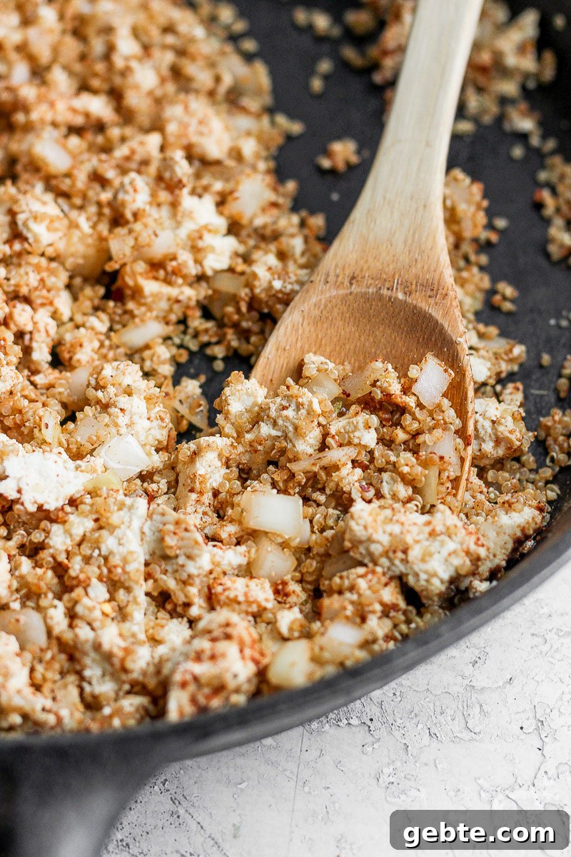 Quinoa and Tofu Taco Filling Recipe for Meatless Tacos 6 skillet with tofu and quinoa taco "meat" in it. spoon hanging out the side
