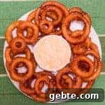 Light and crispy onion rings recipe that are deep fried in a beer batter coating with a cajun dip similar to the kind from Outback Steakhouses Bloomin' Onion.
