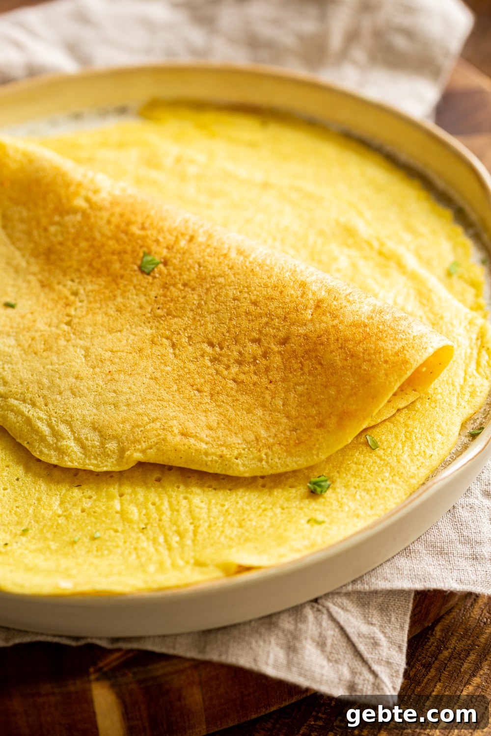 Mung Bean Egg Vegan Omelet: Fluffy Plant-Based Breakfast 4 Plain Vegan Omelet made with Mung Beans on a white plate