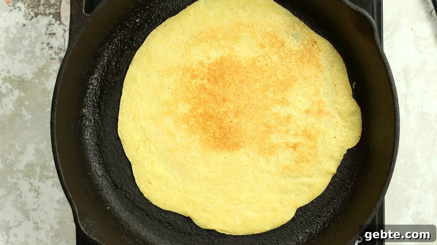 Mung Bean Egg Vegan Omelet: Fluffy Plant-Based Breakfast 8 Plain Vegan Omelet made with Mung Beans on a cast iron skillet