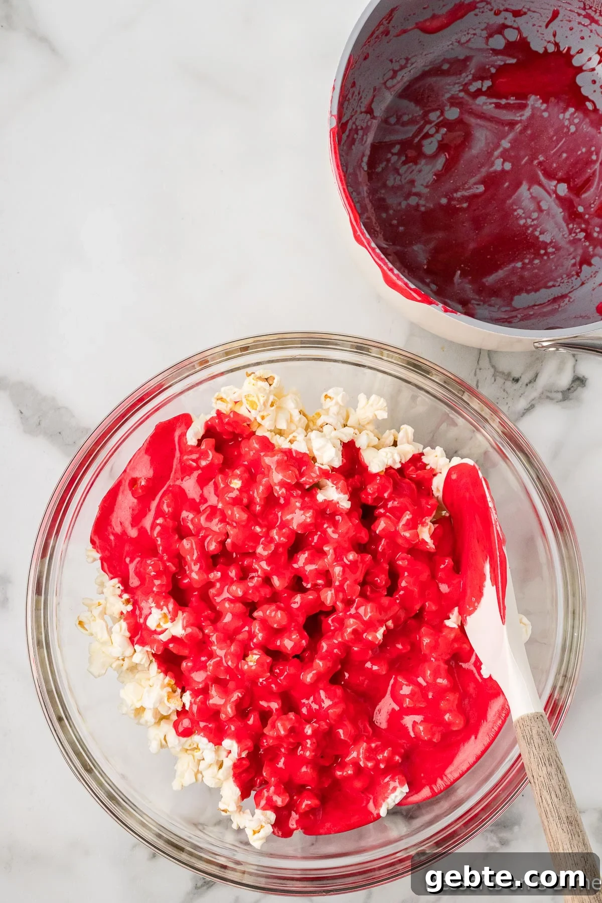 Kool Aid mixture poured over popcorn. 