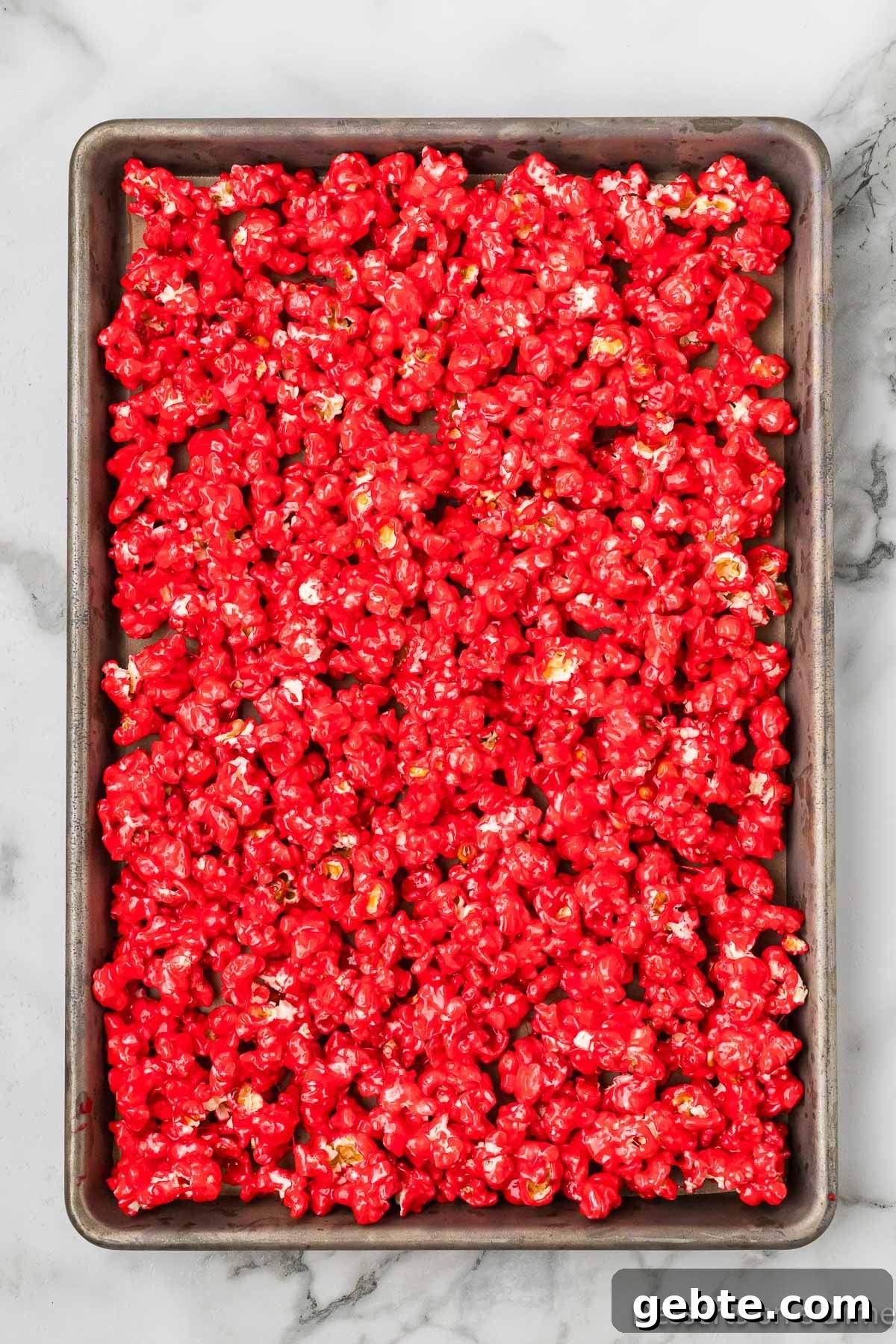 Popcorn spread on baking sheet. 
