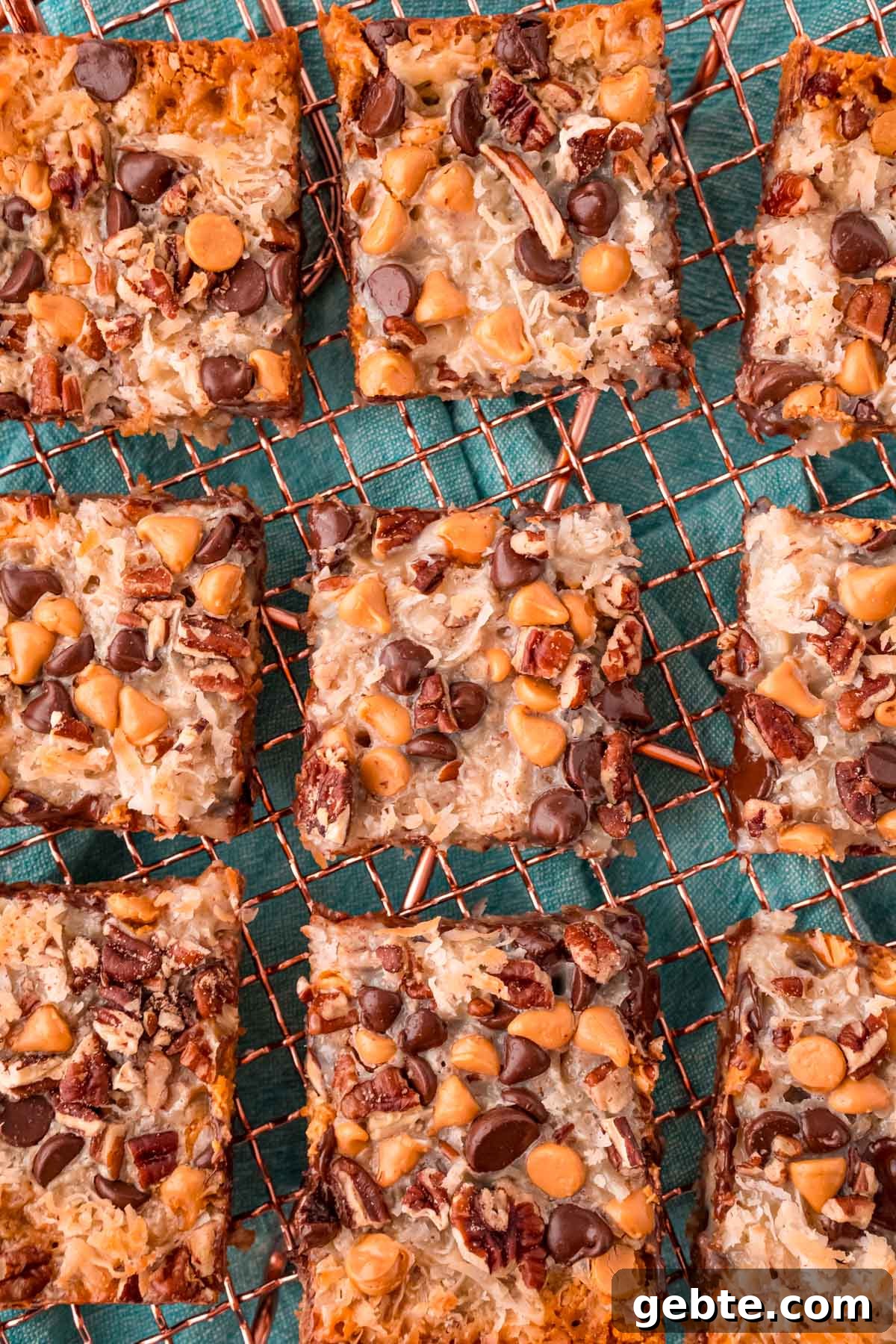 Classic Hello Dolly 7-Layer Cookie Bars Recipe 3 Overhead photo of sliced 7 layer bars on a copper wire rack.