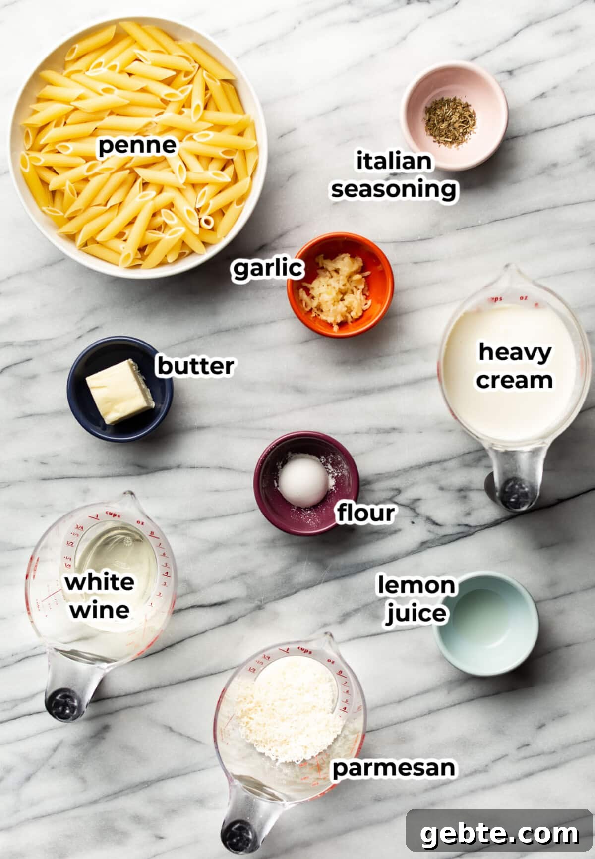 ingredients for creamy penne pasta in prep bowls and measuring cups