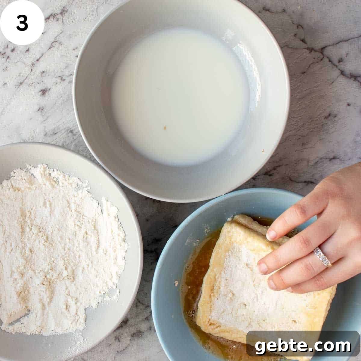 Crispy Mozzarella in Carrozza Sandwiches: Classic Italian Fried Cheese 6 Dipping a sandwich in beaten egg with bowl of milk and bowl of flour on the side.