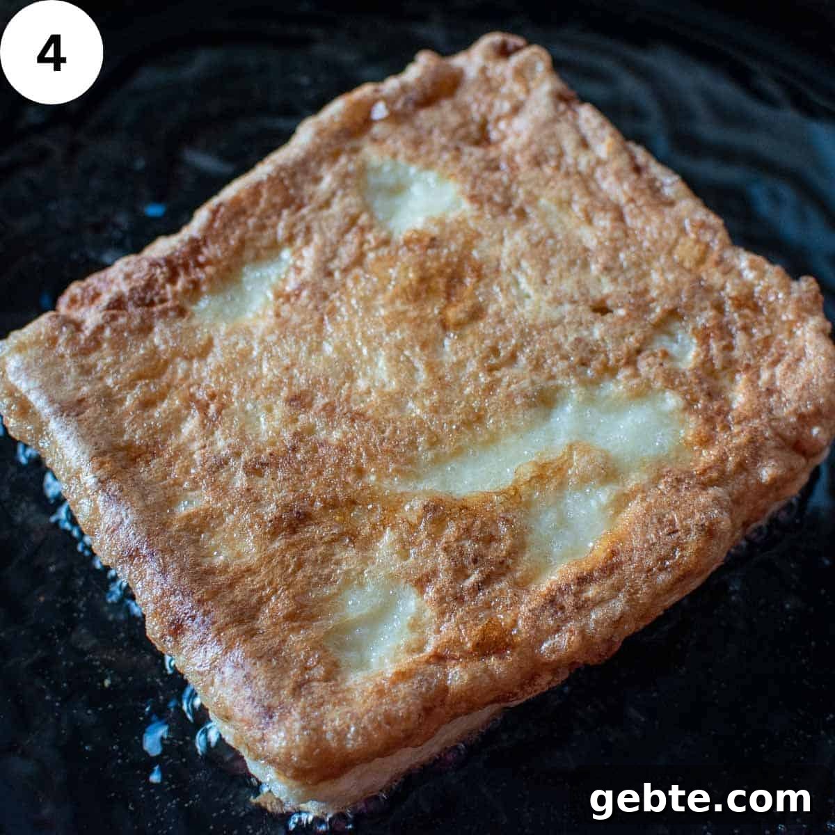 Crispy Mozzarella in Carrozza Sandwiches: Classic Italian Fried Cheese 7 Sandwich of eggy bread frying in oil in a skillet.