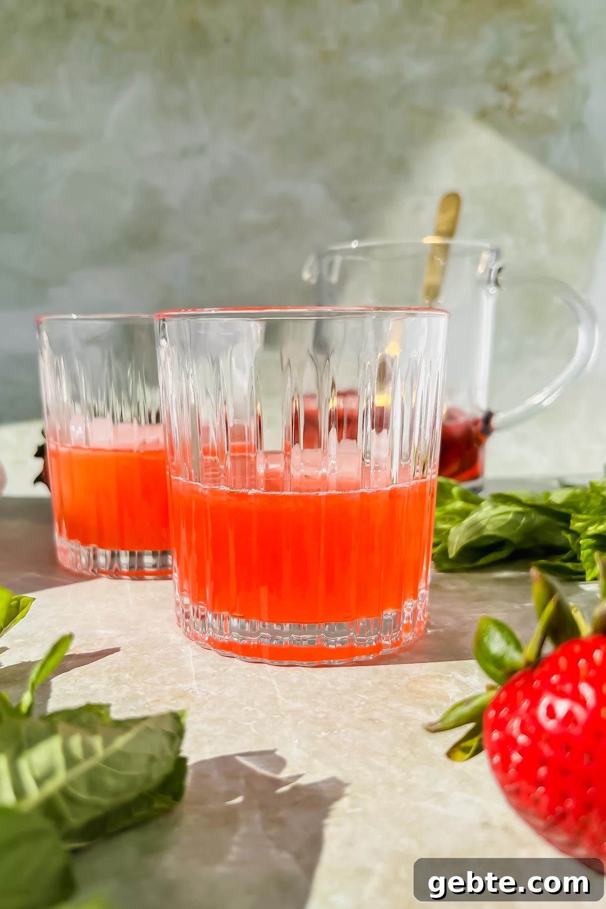 Strawberry Gin Smash: Refreshing Cocktail Recipe for Summer 6 two cocktail glasses filled with strawberry gin smash base before adding club soda.