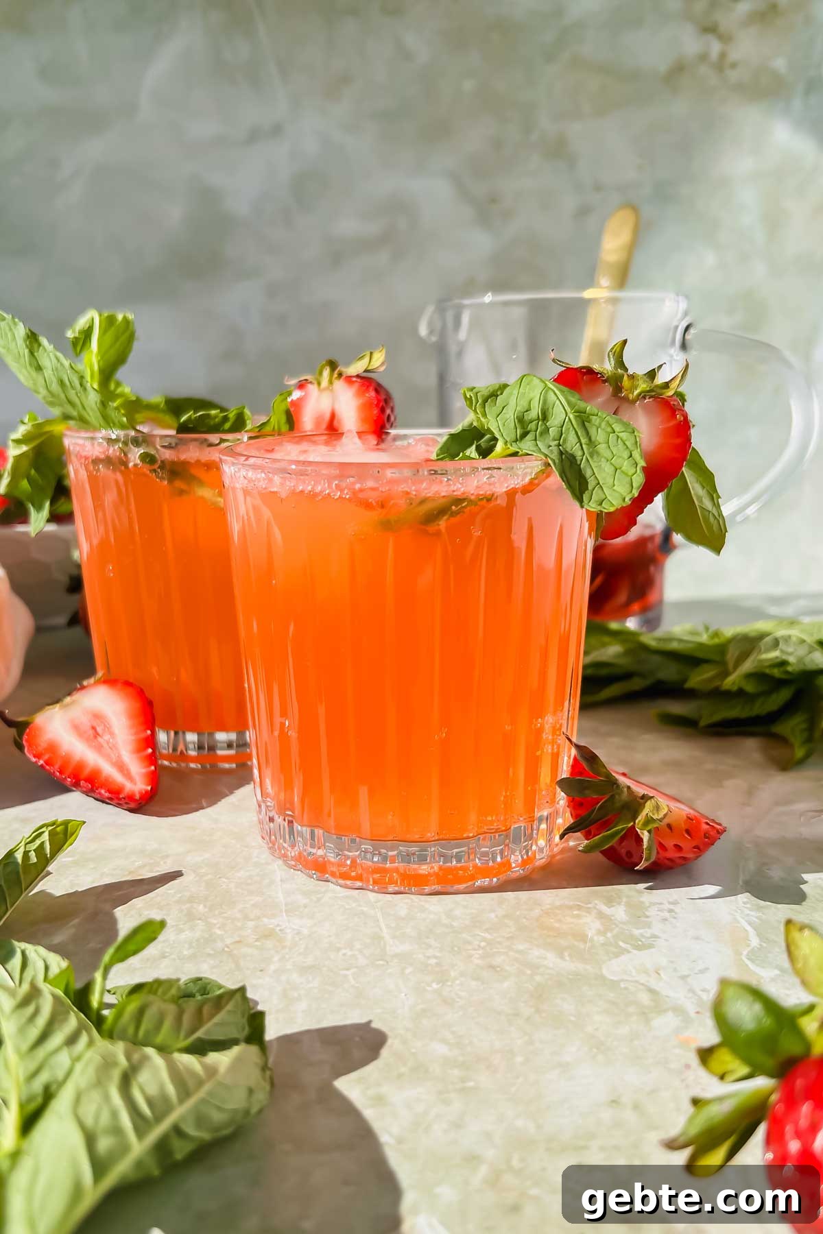 Strawberry Gin Smash: Refreshing Cocktail Recipe for Summer 7 two strawberry gin smash cocktails garnished with mint and fresh strawberry slices.