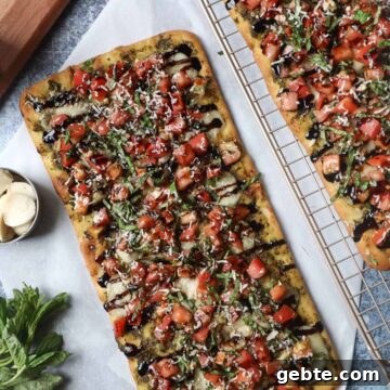 parchment paper with flatbread topped with bruschetta, cheese, and balsamic glaze