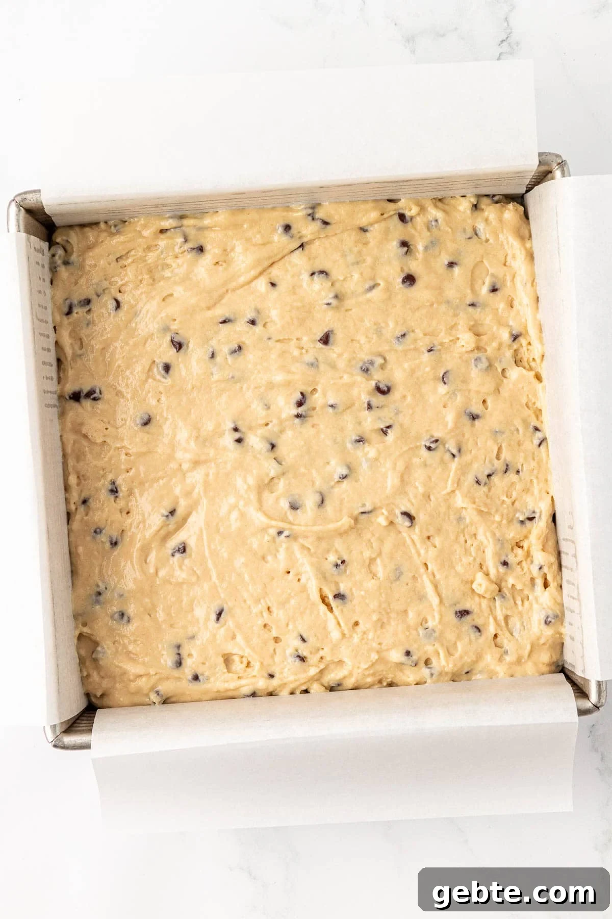 Moist Greek Yogurt Snack Cake with Lemon Glaze 15 greek yogurt cake batter in a lined 8 by 8 baking dish