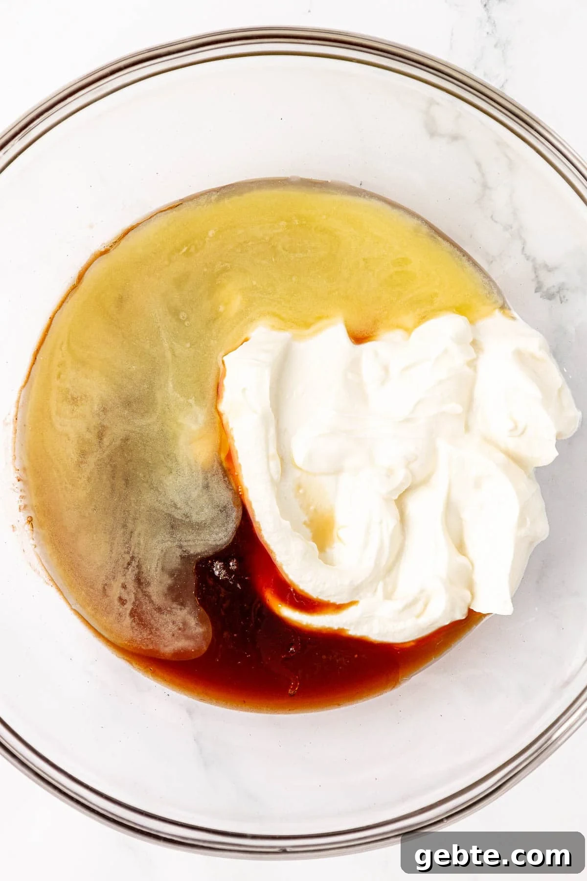 Moist Greek Yogurt Snack Cake with Lemon Glaze 7 wet ingredients in a mixing bowl