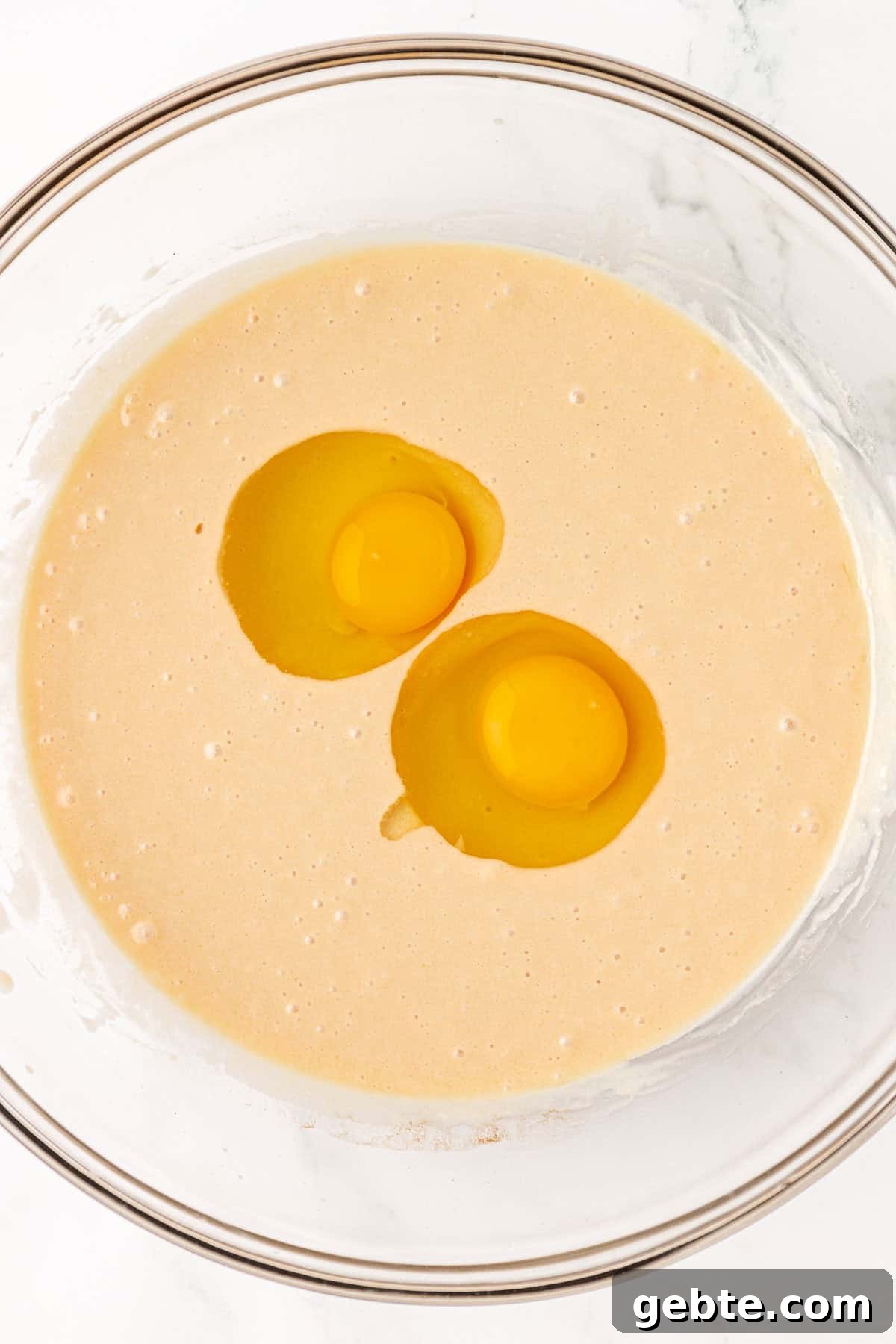 Moist Greek Yogurt Snack Cake with Lemon Glaze 9 adding the eggs to the wet ingredients