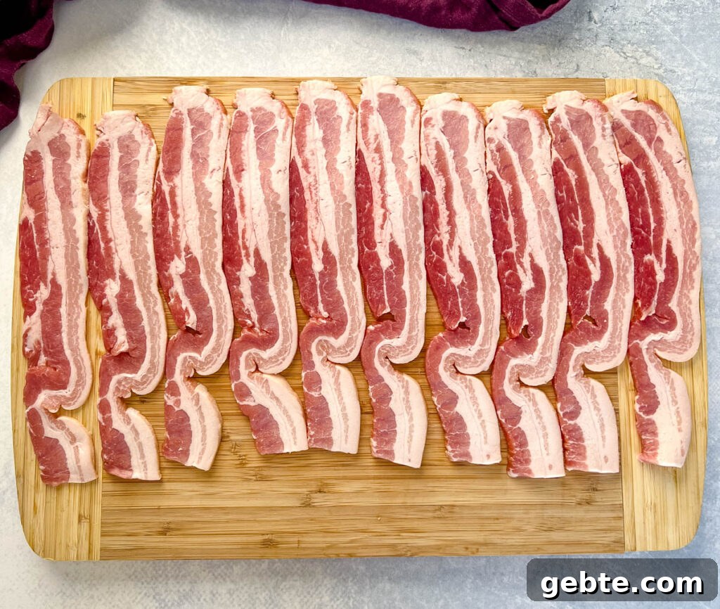 uncooked thick bacon on a cutting board