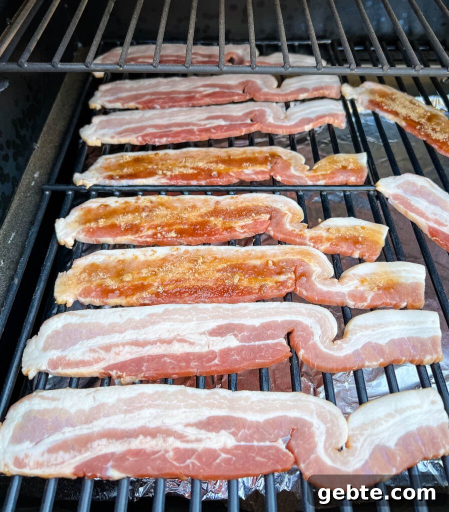 uncooked bacon on a Traeger smoker