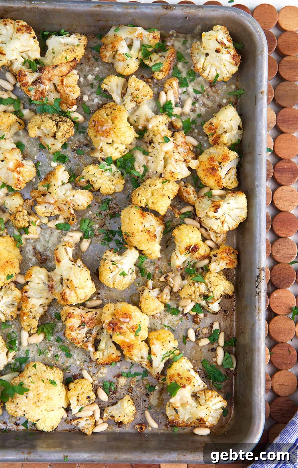 Crispy Oven-Roasted Cauliflower Recipe 4 Roasted cauliflower is spread all over a baking sheet.