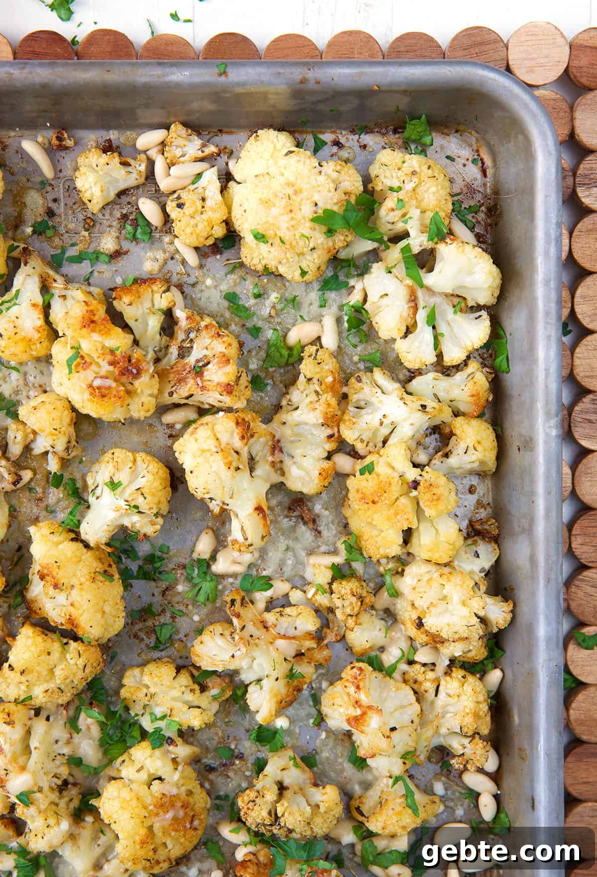 Crispy Oven-Roasted Cauliflower Recipe 5 The corner of a baking pan is filled with roasted cauliflower.