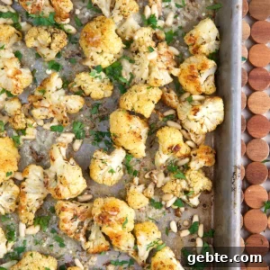 Crispy Oven-Roasted Cauliflower Recipe 6 Roasted cauliflower is spread all over a baking sheet.