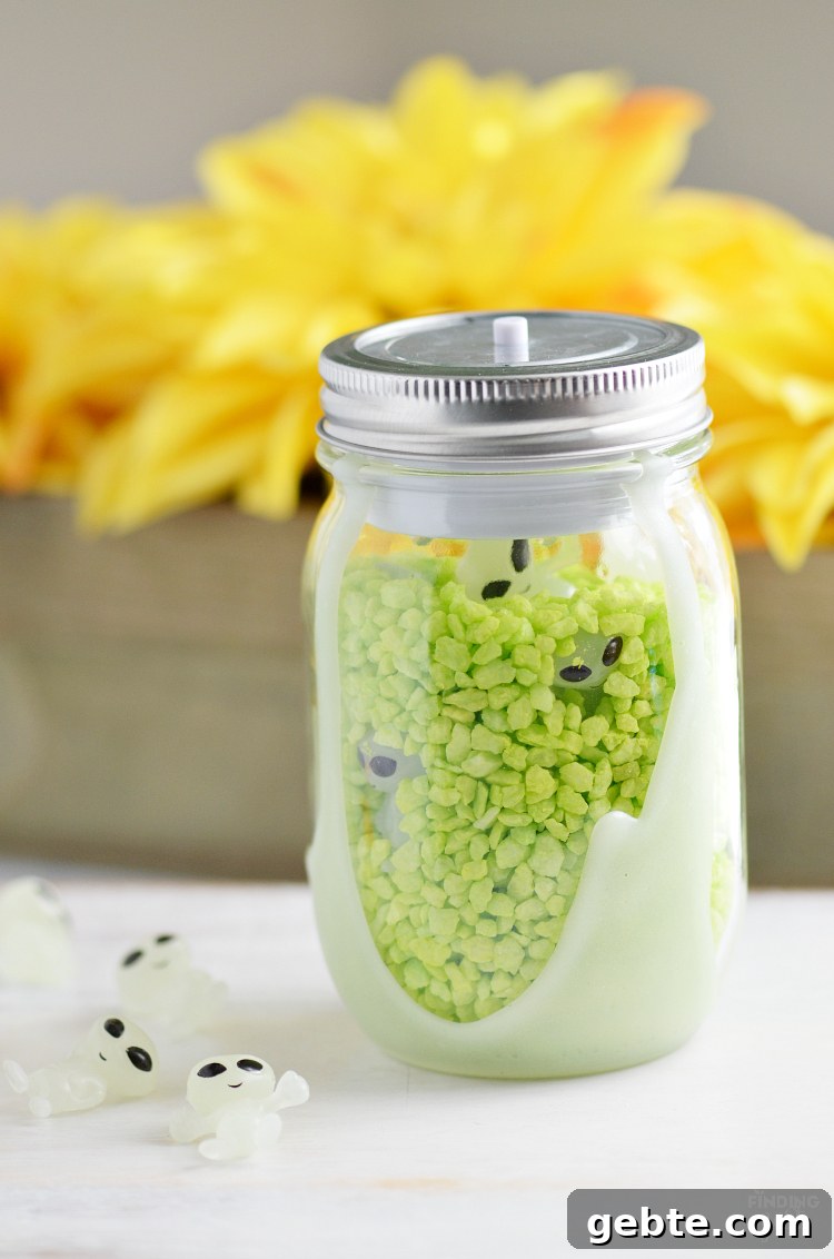Make Your Own Alien Nightlight: DIY Guide for Cool Space Decor 7 Completed mason jar nightlight filled with green rocks and toy aliens.