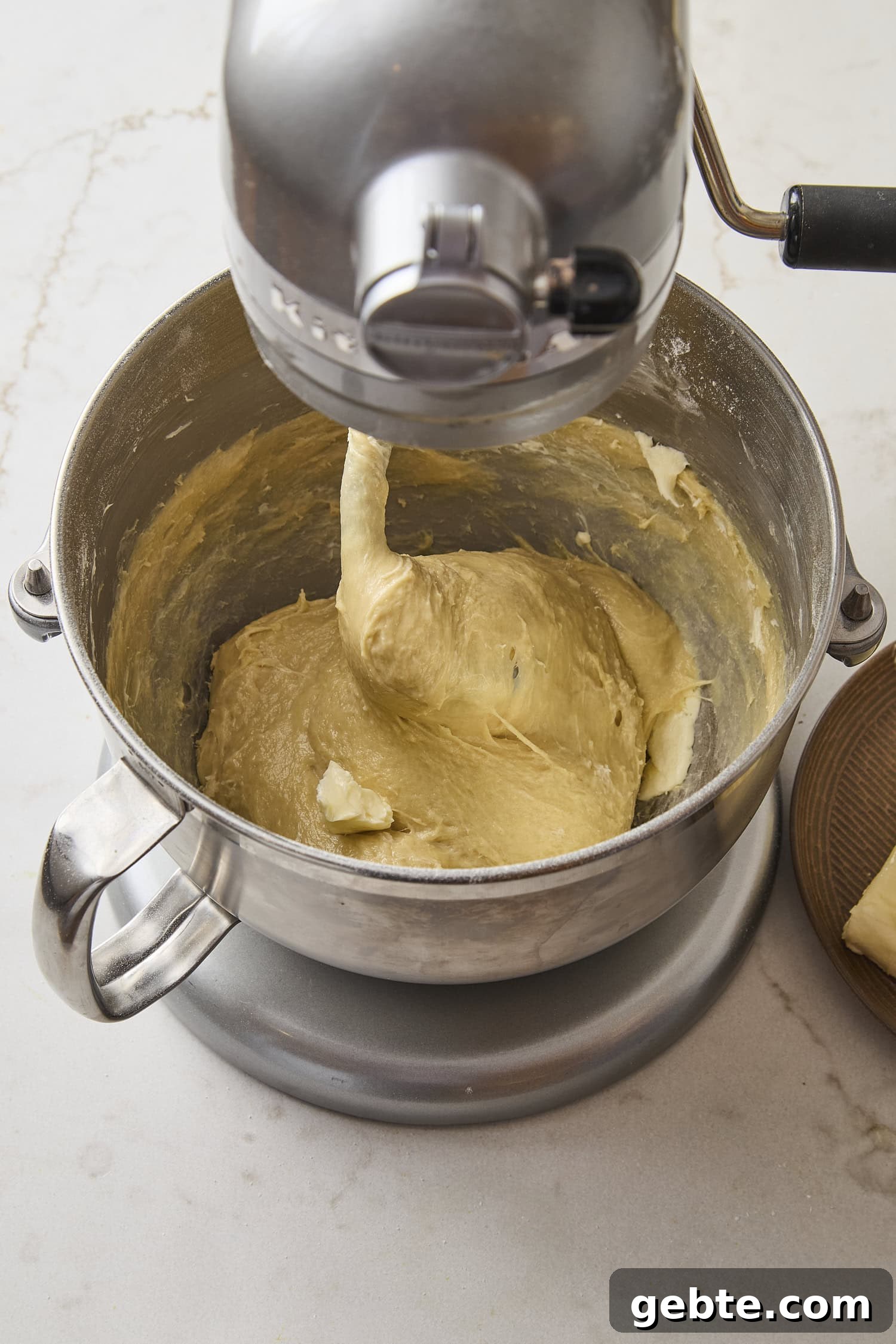 Mixer kneading dough for cinnamon rolls.