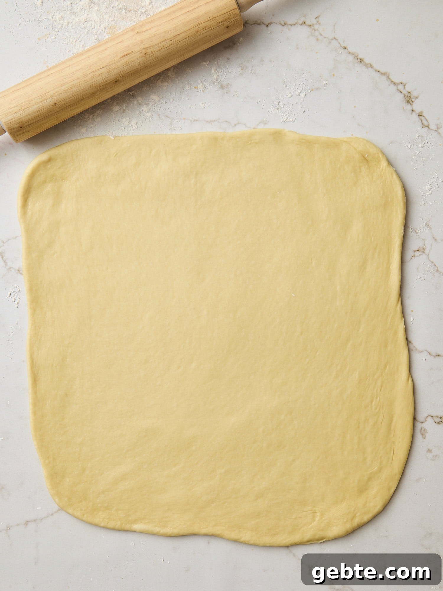 Rolled out brioche dough in a rectangle.