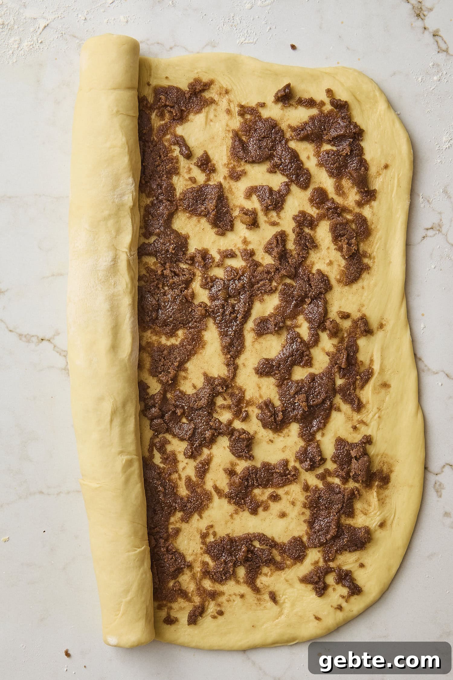 Rolled out dough with cinnamon brown sugar mixture.