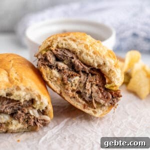 Shredded beef sandwich cut in half.