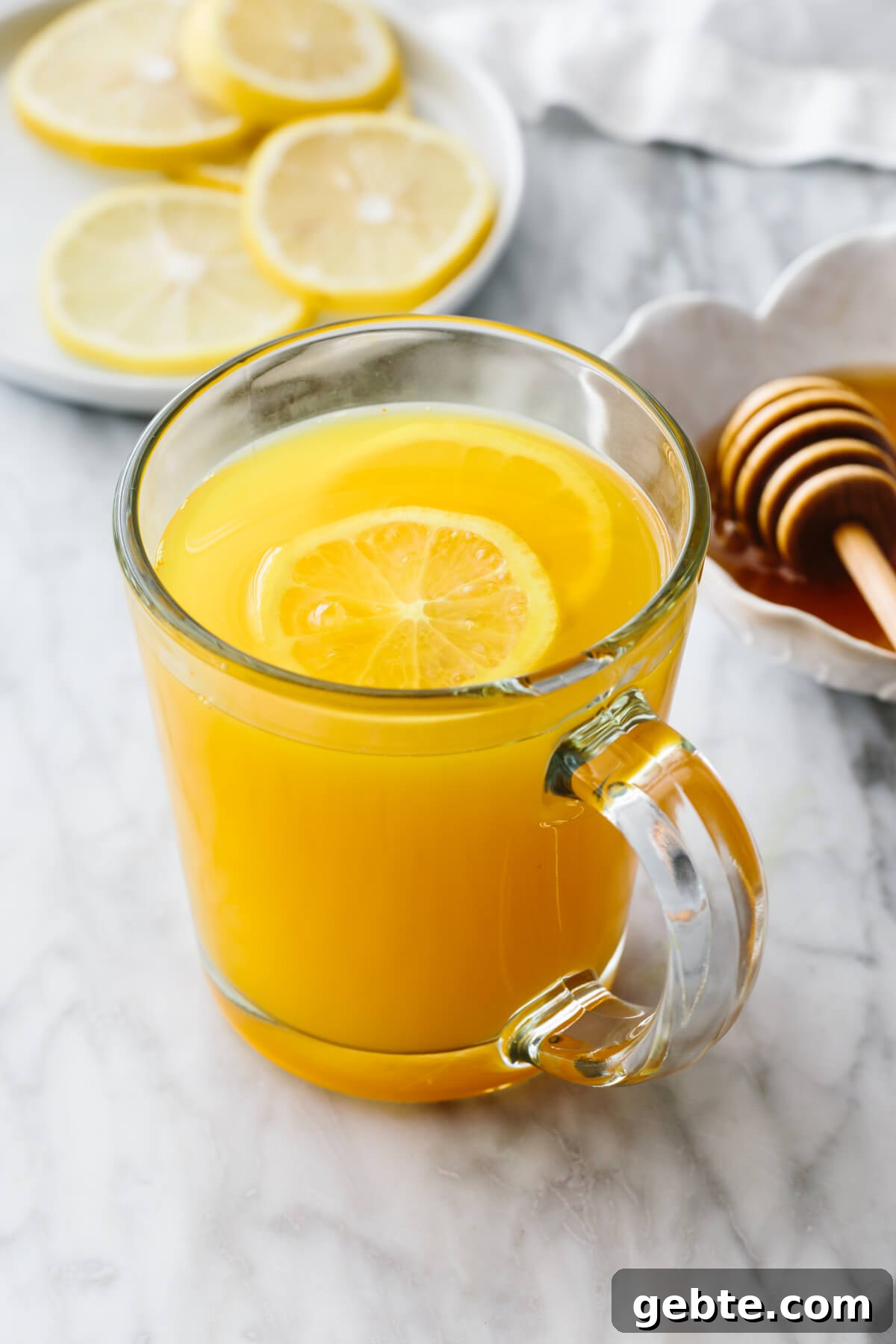 Top Anti-Inflammatory Drinks to Boost Immunity and Reduce Inflammation 3 Turmeric tea in a glass with lemon slices.