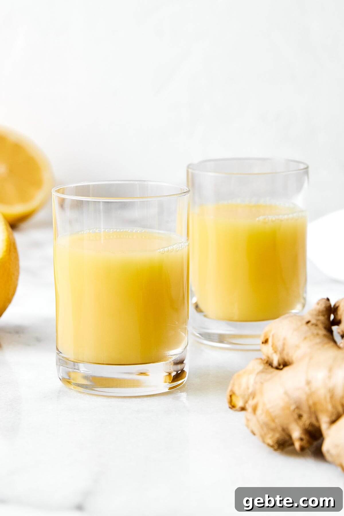 Top Anti-Inflammatory Drinks to Boost Immunity and Reduce Inflammation 4 Ginger shots in glass cups.