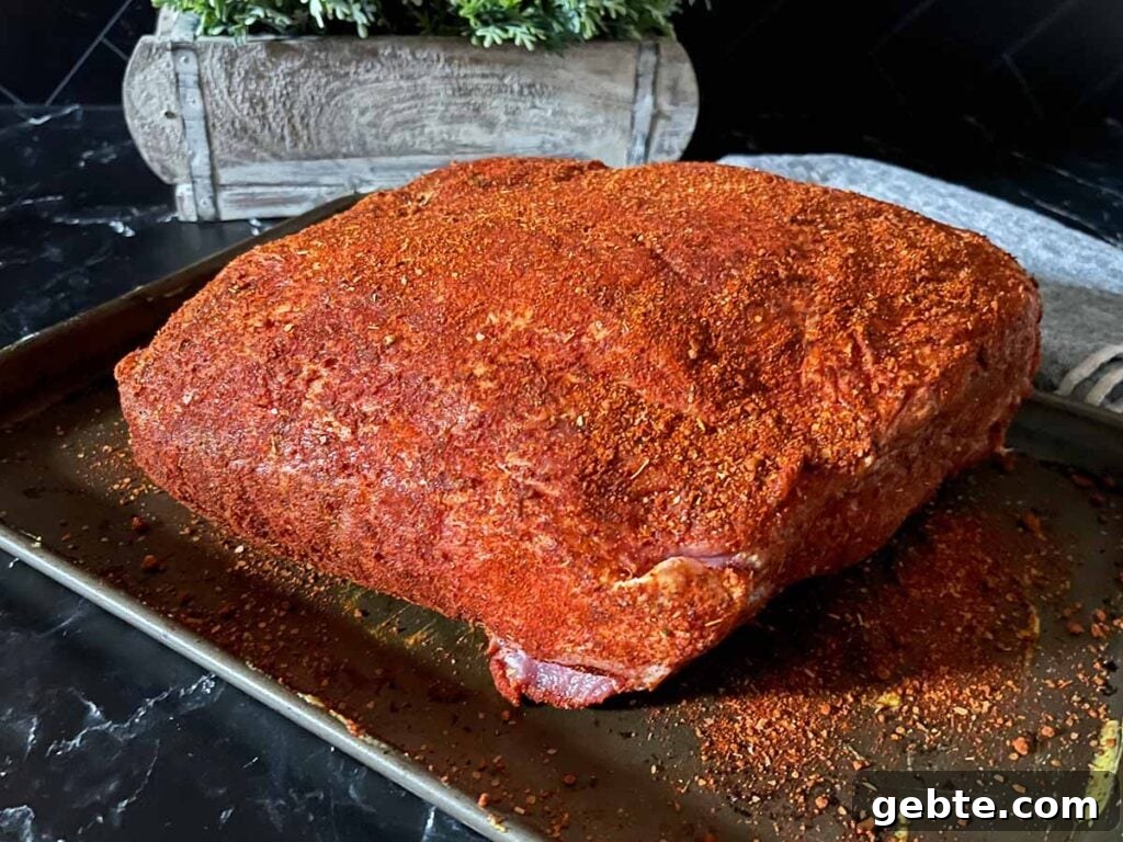 How to Smoke Pork Shoulder (Pork Butt) to Tender Perfection 5 A pork butt with a memphis style rub applied.