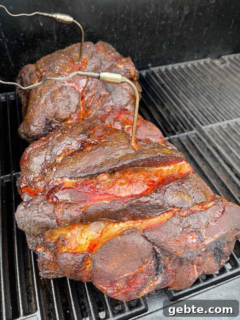How to Smoke Pork Shoulder (Pork Butt) to Tender Perfection 8 Two smoked pork butts at about 6 hours into the smoking process.
