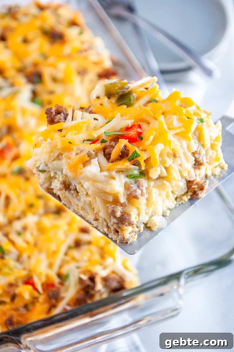 Sausage and Hash Brown Breakfast Casserole Recipe 3 sliced of sausage hashbrown breakfast casserole on a spatula