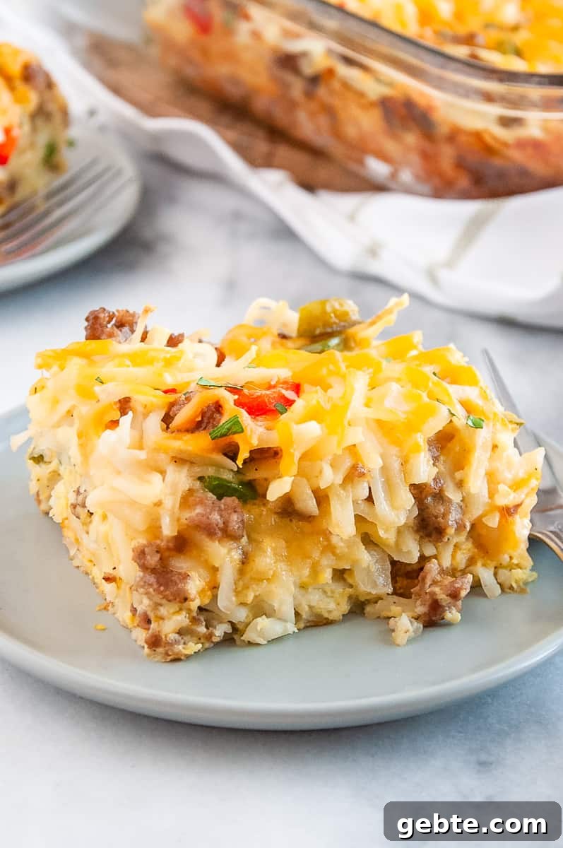 Sausage and Hash Brown Breakfast Casserole Recipe 4 serving of sausage hashbrown breakfast casserole served on a grey round plate