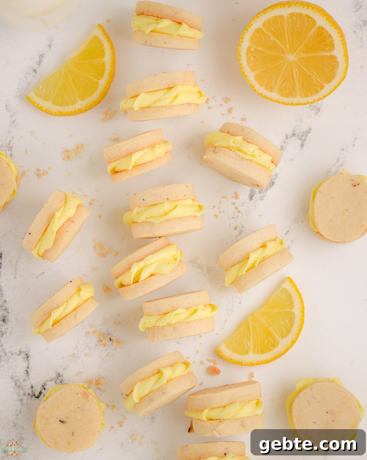 Zesty Lemon Sandwich Cookies Recipe for Homemade Treats 2 lemon sandwich cookies with lemon frosting piped in the middle